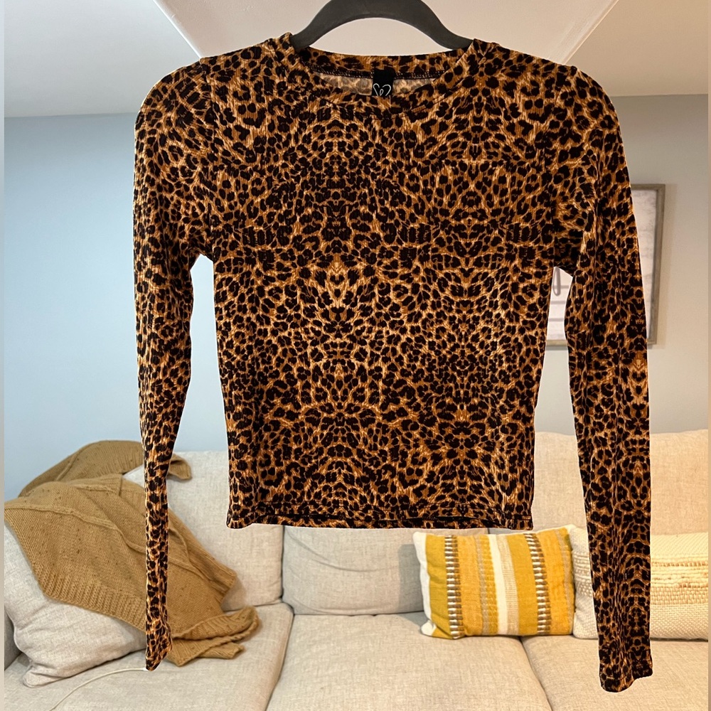 Leopard long sleeve crew neck, semi-cropped hem, and a fitted silhouette
